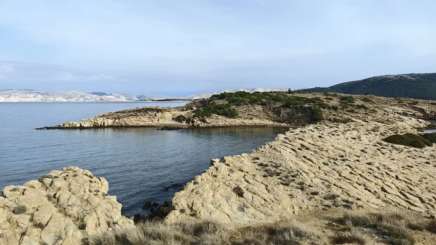 Sandy cove with characteristic Lopar rock