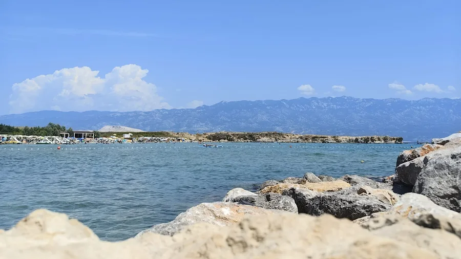 Summer beach with Velebit mountain view
